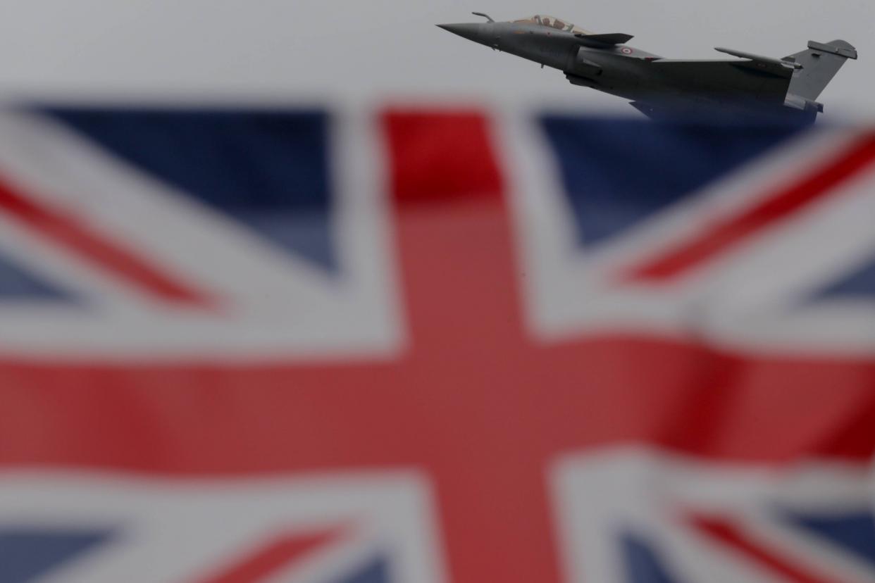 Image: A French Air Force Dassault Rafale fighter jet seen behind the Union Jack flag of Great Britain