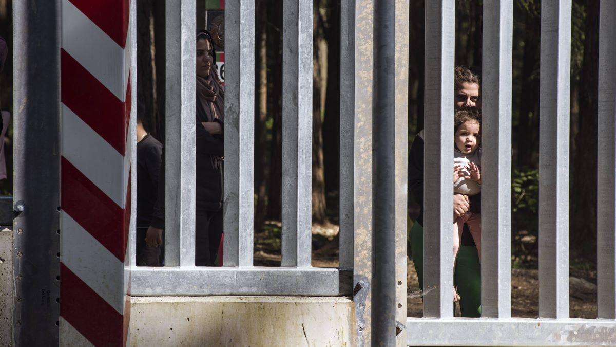 May 28, 2023, Bialowieza, Podlaskie, Poland: Migrants with children seeking asylum are seen at the Belarusian side of the Polish border wall in Bialowieza.