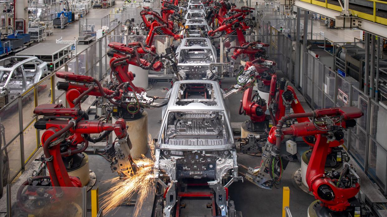 Robotic arms work on the assembly line of C11 electric SUV at a factory of Chinese EV startup Leapmotor on April 26, 2023 in Jinhua, Zhejiang Province of China.